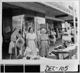 [Photograph of two women posing at a city sidewalk sale, Bainbridge, Decatur County, Georgia, ca. 1969]