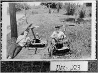 [Photograph of two young men taking a break from mowing the lawn, Decatur County, Georgia, 1958 May]