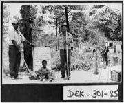 [Photograph of African-Americans cleaning up a cemetery, Lithonia, DeKalb County, Georgia, not before 1952]