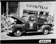 [Photograph of man trying to repair a disabled Emanuel County Forestry Unit truck, Swainsboro, Emanuel County, Georgia, 195-]