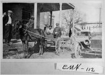 [Photograph of wagon and automobile parked in front of the Durden Hotel, Swainsboro, Emanuel County, Georgia, 192-]