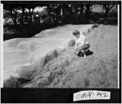 [Photograph of Quida Fields treating her land so that she can plant strawberries, Swainsboro, Emanuel County, Georgia, 1965]
