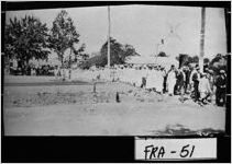 [Photograph of crowds walking across railroad tracks on way to county school fair, Lavonia, Franklin County, Georgia, not after 1914]