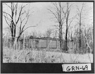 [Photograph of a structure behind bare trees, Greene County, Georgia, 1976]