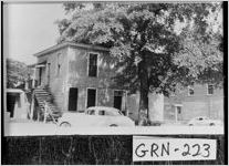 [Photograph of a building with a large tree and a car in front, Greensboro, Greene County, between 1930 and 1949]