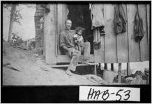 [Photograph of man and young child in doorway of cabin, Clarkesville, Habersham County, Georgia, ca. 1907]