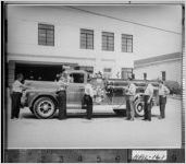 [Photograph of members of the Gainesville Fire Department standing around a new fire engine, Gainesville, Hall County, Georgia, 1957 Aug.]