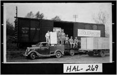 [Photograph of City Ice Company employees displaying a refrigerator, Gainesville, Hall County, Georgia, ca. 1939]
