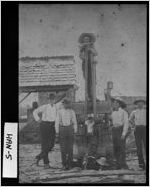 [Photograph of men dehorning a calf, Hancock County, Georgia, ca. 1900]