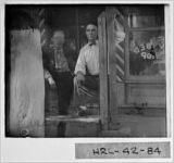 [Photograph of Ben Davis (left) in front of his barbershop, Buchanan, Haralson County, Georgia, 1927]