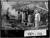 [Photograph of Sheriff Carey Carter and helpers at a copper moonshine still, Hart County, Georgia, 1948 Mar. 24]