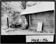 [Photograph of Mamie Wyche posing by her house, Monroe County, Georgia, 194-]