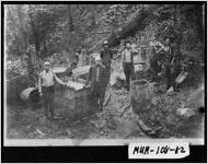 Photograph of men standing around destroyed barrels, Murray County, Georgia