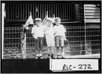 [Photograph of two Chinese children and another boy holding American flags behind Central School, Augusta, Richmond County, Georgia, 1927 June]