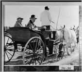 [Photograph of two men being driven in a carriage, Thomas County, Georgia]