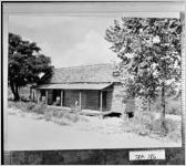 [Photograph of small boy on the porch of a tenant farmhouse, Troup County, Georgia, ca. 1933]
