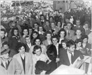[Photograph of a large group of people at a Liberty ship launching, J.A. Jones Construction Company shipyard, Brunswick, Georgia, 1943]