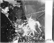 [Photograph of Mrs. I. M. Aiken christening the Liberty ship George W. Crawford, J.A. Jones Construction Company shipyard, Brunswick, Georgia, 1944 Jan. 1?]