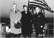 [Photograph of Emil J. Kratt with two other men at the launching of the Liberty ship Howard E. Coffin, J.A. Jones Construction Company shipyard, Brunswick, Georgia, 1944 Jan. 21?]