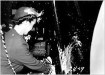 [Photograph of Mrs. Alfred W. Jones christening the Liberty ship Howard E. Coffin, J.A. Jones Construction Company shipyard, Brunswick, Georgia, 1944 Jan. 21]