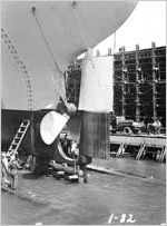 [Photograph of workers looking at the rudder and screw propeller of a Liberty ship, J.A. Jones Construction Company shipyard, Brunswick, Georgia, 1943-1945?]