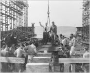[Photograph of shipyard workers praying during the laying of a Liberty ship keel, J.A. Jones Construction Company shipyard, Brunswick, Georgia, 1943-1945?]
