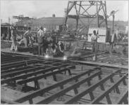 [Photograph of workers welding parts of a Liberty ship together, J.A. Jones Construction Company shipyard, Brunswick, Georgia, 1943]