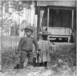 [Photograph of two children standing in front of house in Richmond County, Georgia, in late 19th century]