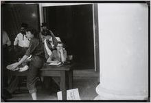 Photograph of women and men at the "old timers" registration table in front of the Worth County Courthouse during the Worth County Centennial Celebration in Sylvester, Worth County, Georgia, 1953 October