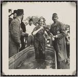 Photograph of Shirley Geeslin being helped out of the water by Bud Bius during the "Crime and Punishment" part of the Worth County Centennial Celebration in Sylvester, Worth County, Georgia, 1953 October