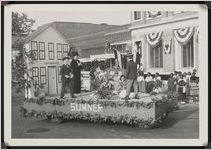Photograph of Billy Hatcher, Charlotte Whitten, Andrea Hudson, and other unidentified children on the Sumner float in a Worth County Centennial Celebration parade in Sylvester, Worth County, Georgia, 1953 October