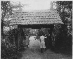 Photograph of three students walking through the Girls School gateway, Mount Berry, Georgia, 19XX