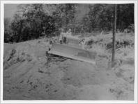 Photograph of an unidentified man using a grader at the construction site of the new housing project, Manchester, Georgia, 1952