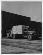 Photograph of city garbage truck with unidentified worker, Manchester, Georgia
