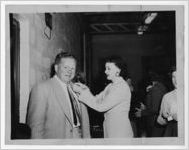 Photographof a woman greeting a man at a fund raiser, Manchester, Georgia, 1953