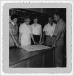 Photograph of men and women examining library plans, Manchester, Georgia, 1953