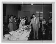 Photograph of men and women in a buffet line, Manchester, Georgia, 1953
