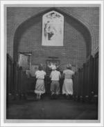 Photograph of people kneeling at the altar of a church, Manchester, Georgia, 1953