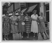 Photograph of American Legion Auxiliary members selling brooms, Manchester, Georgia, 1953