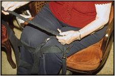 Braided rug work: Priscilla Hardison. Priscilla Hardison holds a newly braided wool strip of cloth
