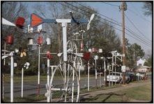 Whirligigs: John Byrd. View of whirligigs lining the front of John Byrd's home