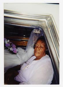 Color photograph of an unidentified older African American woman and a younger African American woman (possibly a bride or beauty queen) in a veil, crown, and white dress