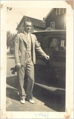 Photograph of Johnny Mize in suit with unidentified man in car