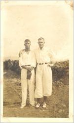 Photograph of Johnny Mize in golf outfit with arm around unidentified man