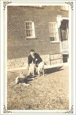 Photograph of Johnny Mize with three dogs