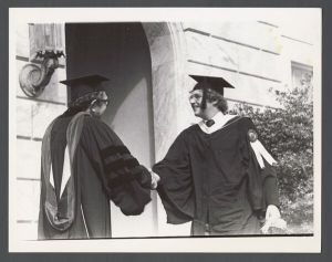 Commencement, 1970s - Student shakes hands with professor