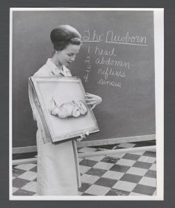 School of Nursing - Woman holding a painting of a baby