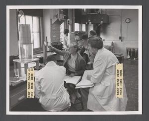 School of Medicine - Students review notes while looking at equipment