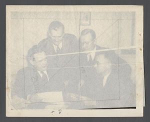 Journalism Department - Men reading a document