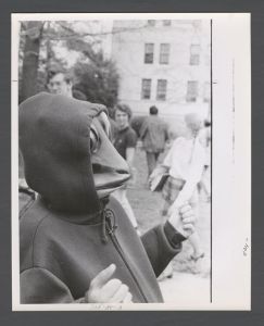Students, groups, 1970s - Student wearing frog mask on quad